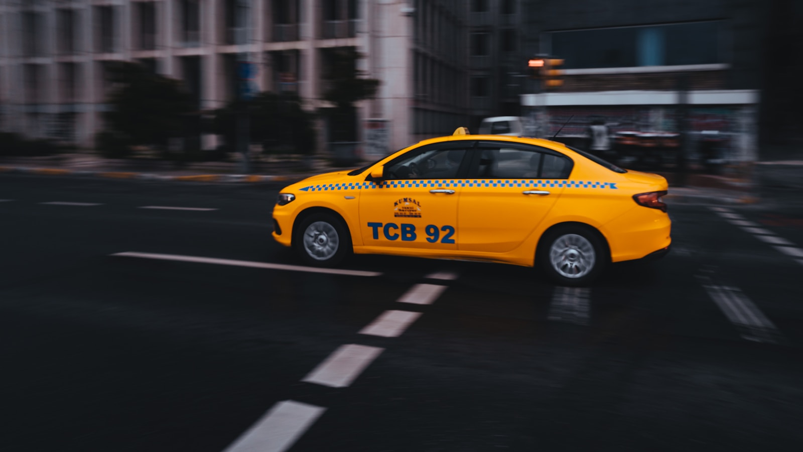 yellow taxi cab on road during daytime